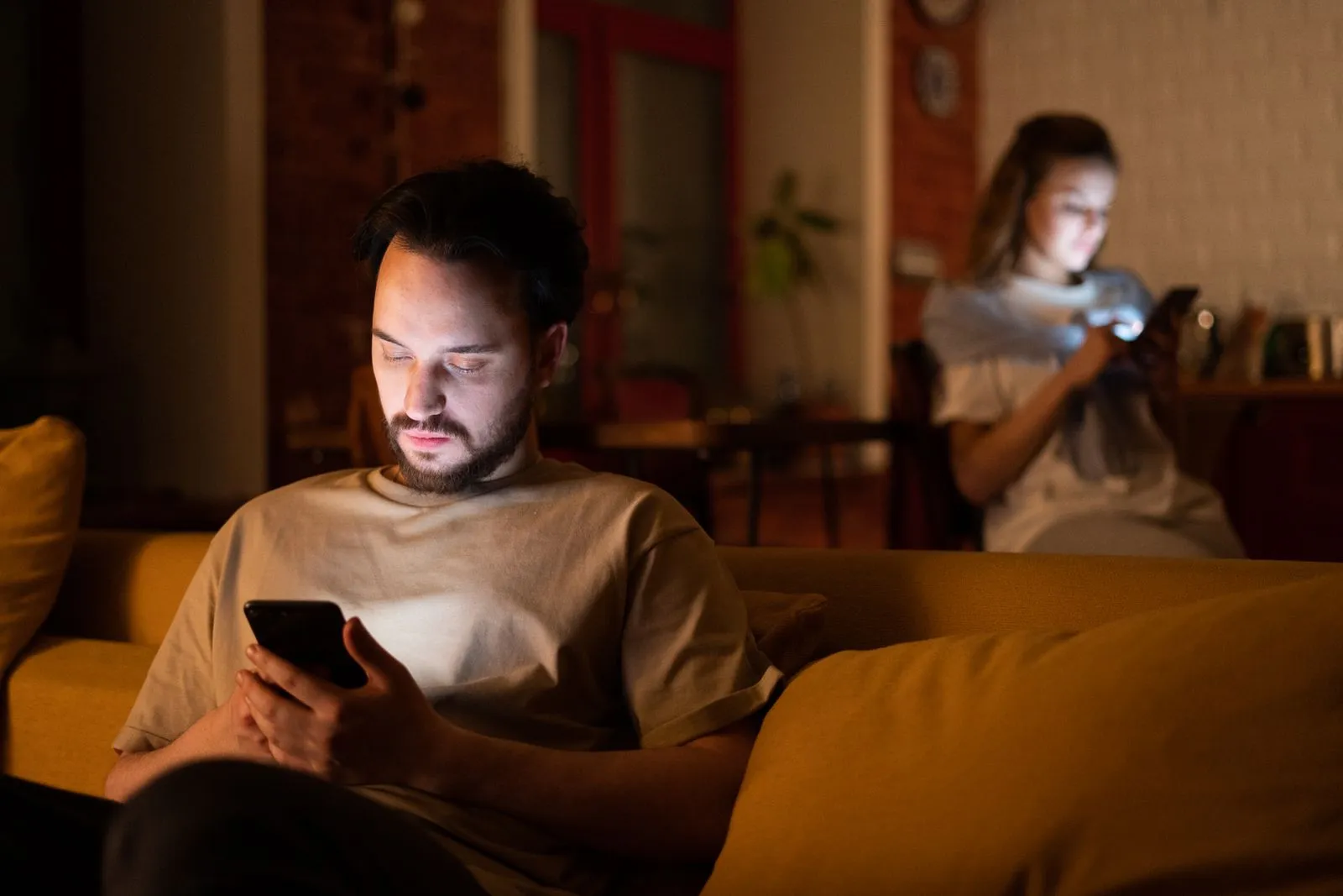 A couple lying together looking at a phone